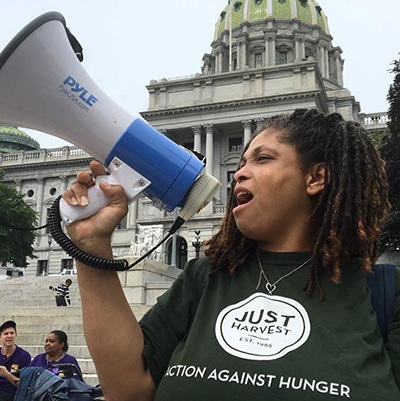 Just Harvest activist member Godina on the steps of the Capitol Building in Harrisburg